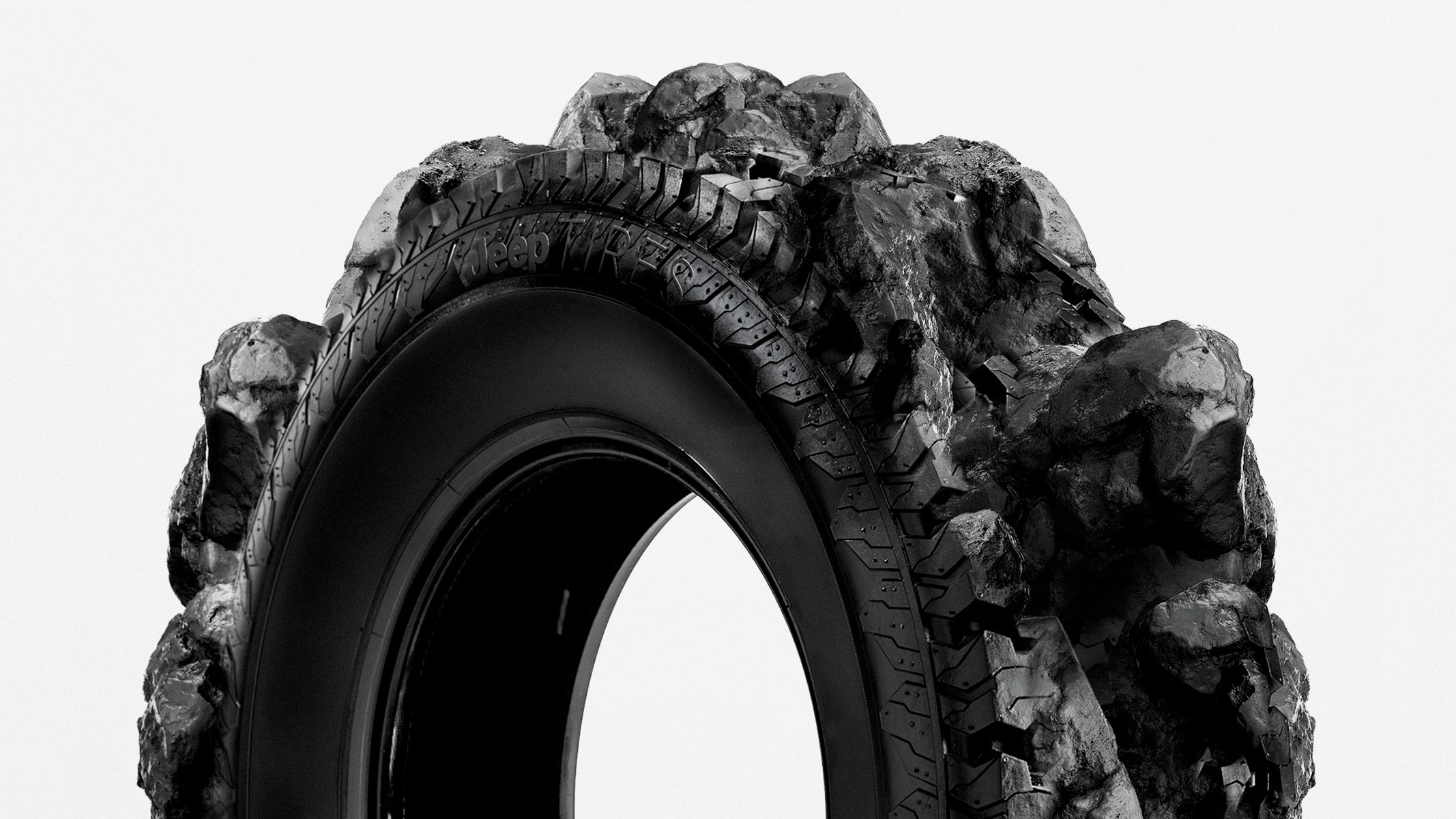 Eine Fotomontage von einem Gummireifen, der ein Profil hat, das aussieht wie Berggestein.
